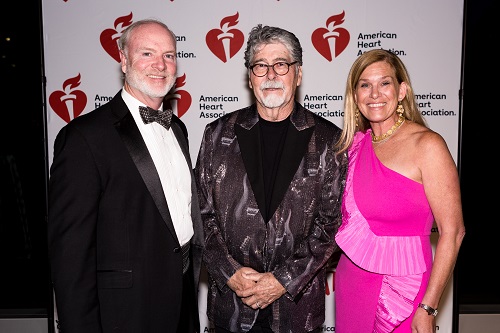 Three people standing in front of American Heart Association 100 Years of Bold Hearts backdrop